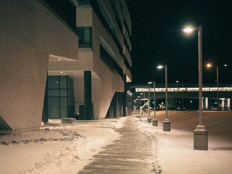 a sidewalk covered in ice next to a building