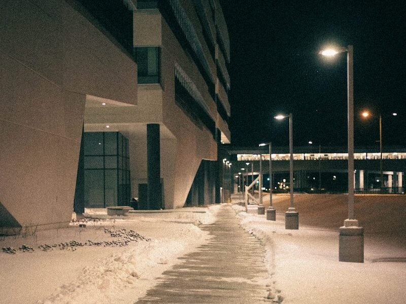 a sidewalk covered in ice next to a building