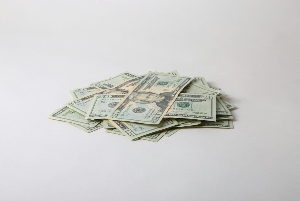a pile of money sitting on top of a white table